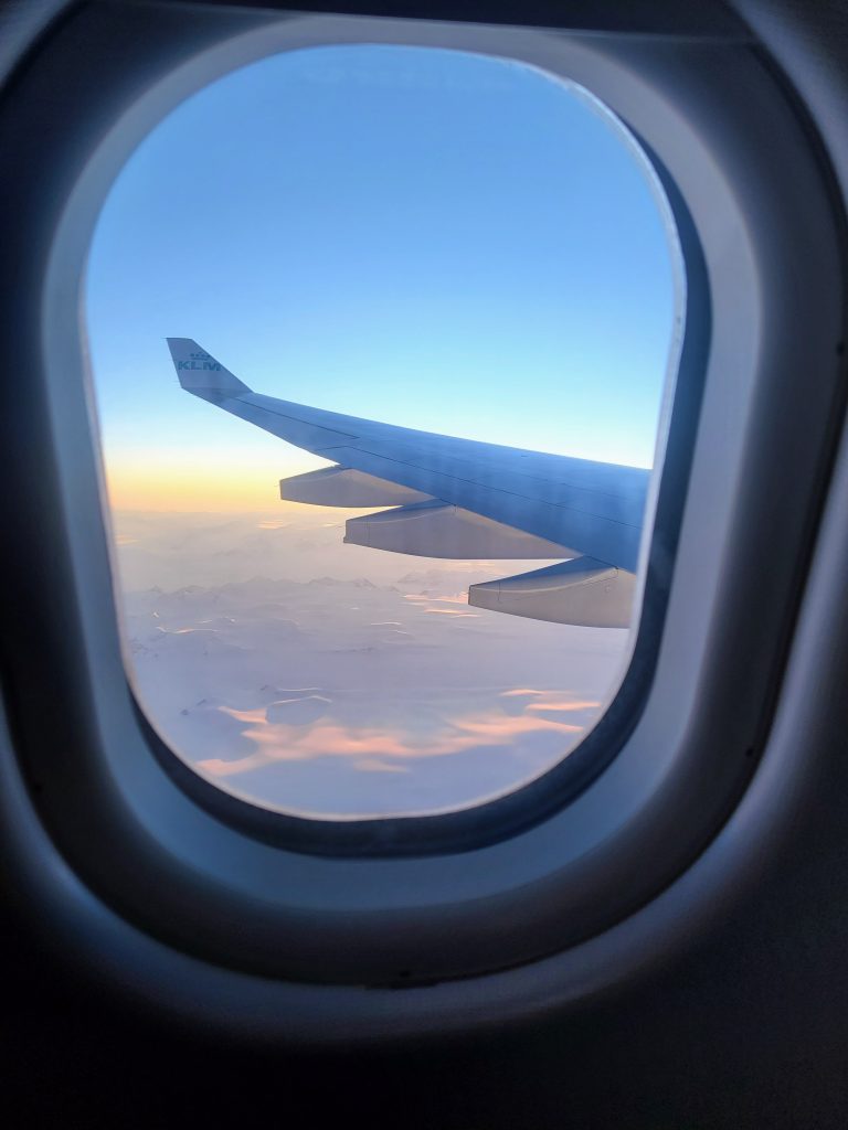 View of the Greenland Ice Cap at dawn seen through an aircraft window